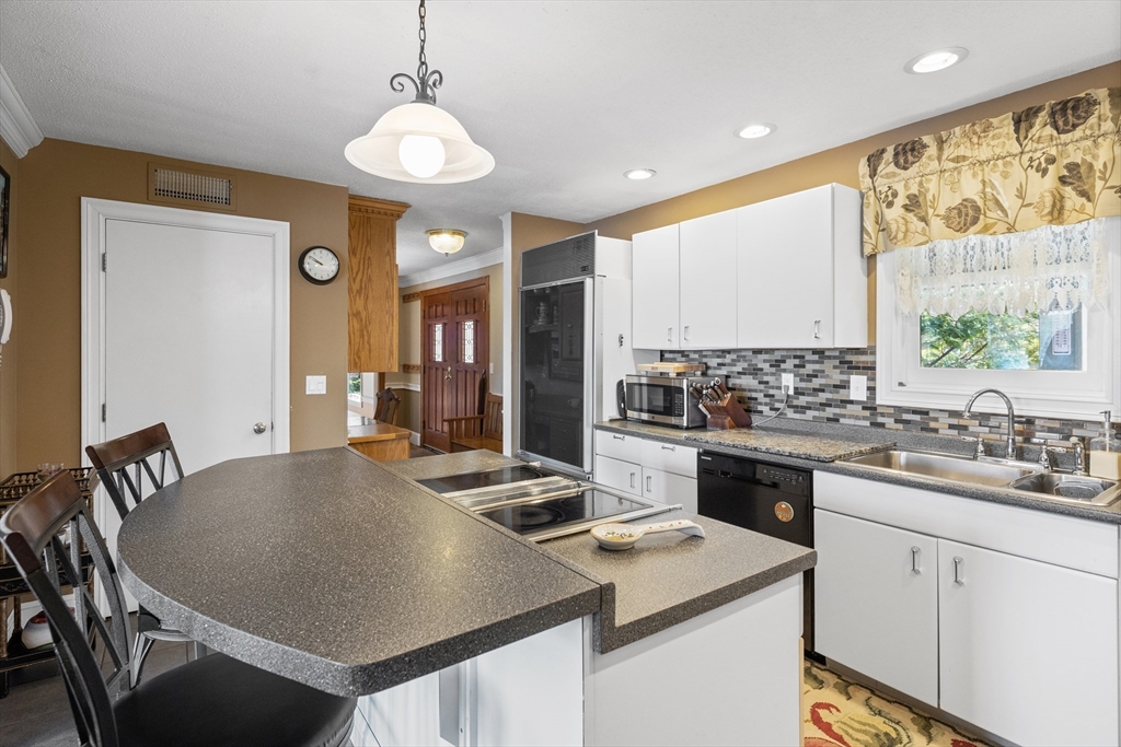 152 Kimball Road Amesbury, MA 01913 - Photo 10 of 20 a kitchen with a table chairs stove and refrigerator