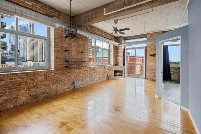 a view of an entryway with wooden floors and door