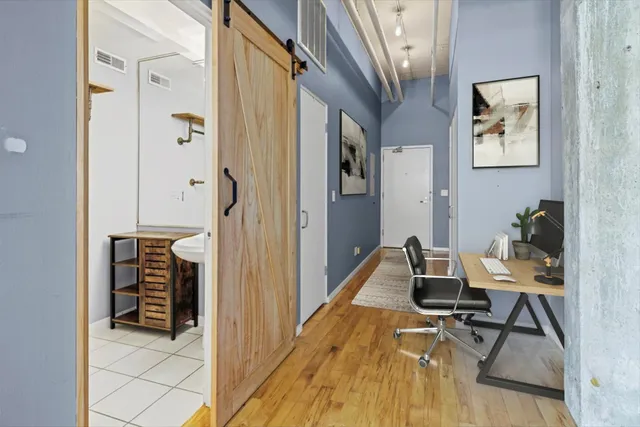 a workspace with wooden floor and furniture