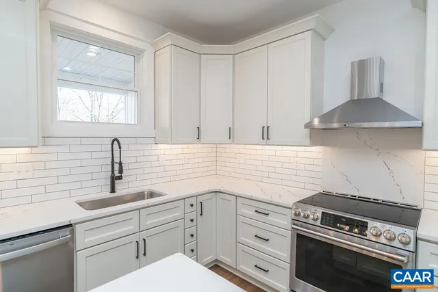 a kitchen with a stove a refrigerator and a sink