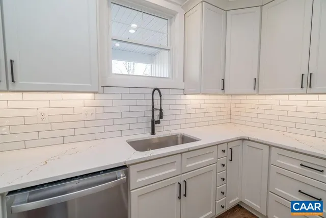 a kitchen with cabinets appliances and a window