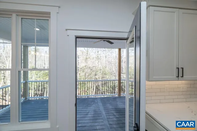 a view of entryway with window and wooden floor
