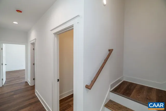 a view of hallway with wooden floor