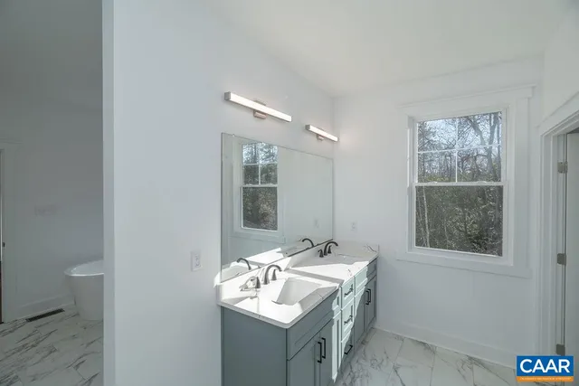 a bathroom with a sink toilet and mirror