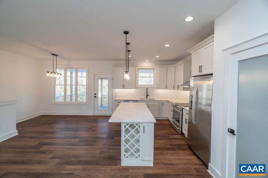 Lot 5 Frays Mill Road Ruckersville, VA 22968 - Photo 8 of 54 a large kitchen with kitchen island a stove a refrigerator wooden floor and a dining table
