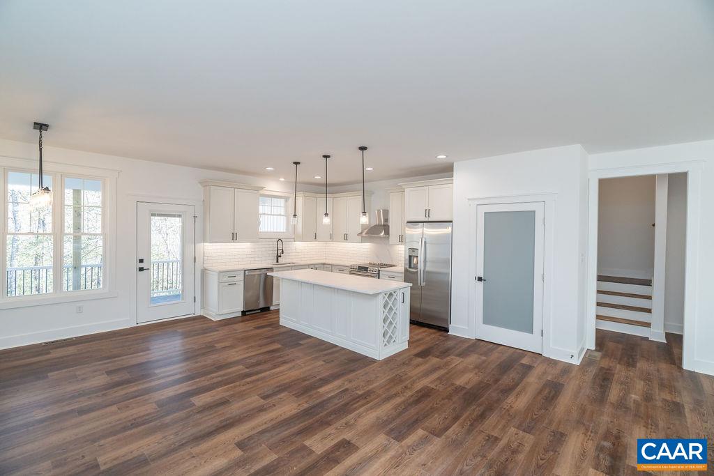 Lot 5 Frays Mill Road Ruckersville, VA 22968 - Photo 9 of 54 a large white kitchen with kitchen island a sink wooden floor and a refrigerator