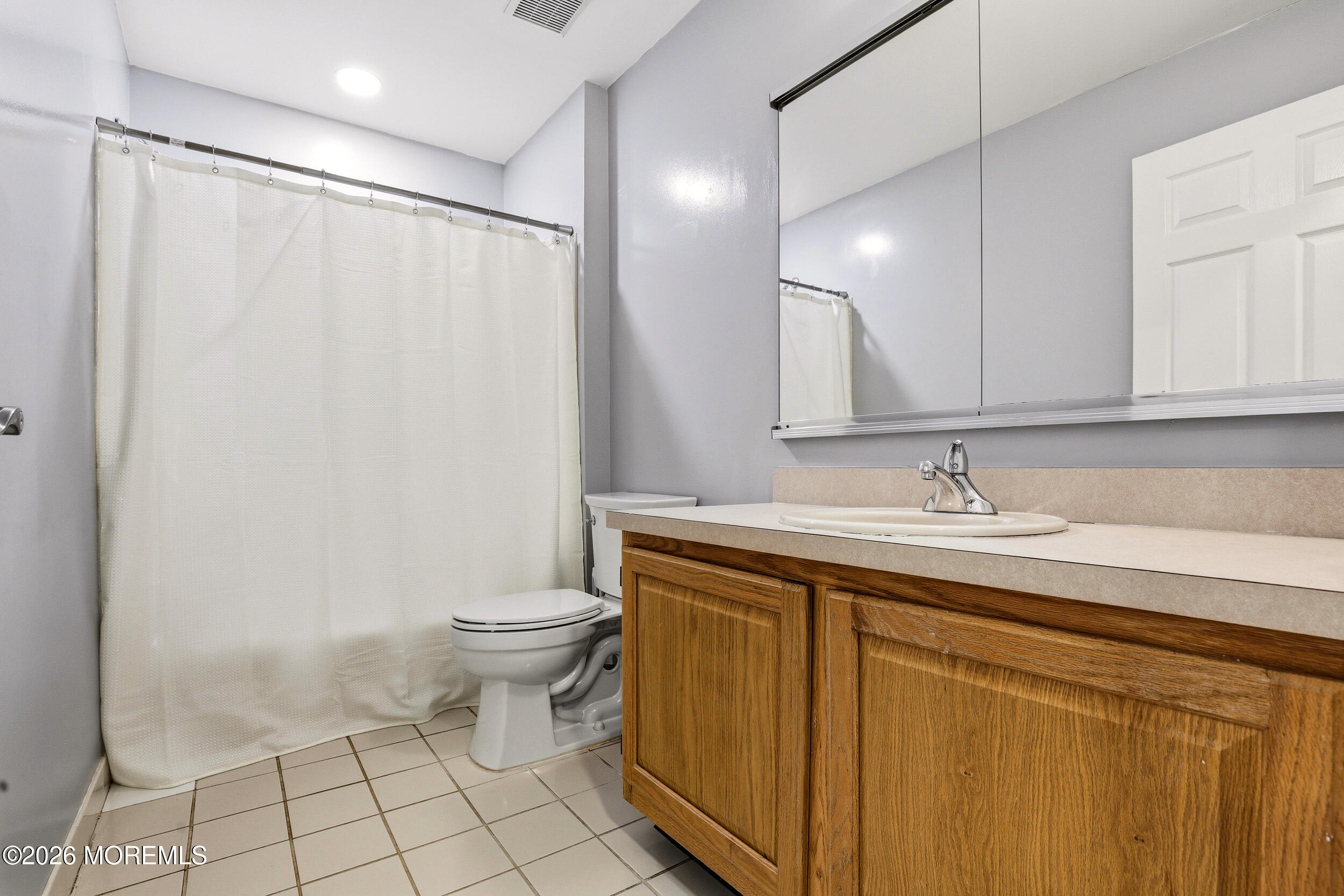 2055 MacKenzie Road Toms River, NJ 08755 - Photo 29 of 56 a bathroom with a sink a toilet and a mirror