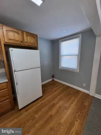 a view of a kitchen with microwave and refrigerator