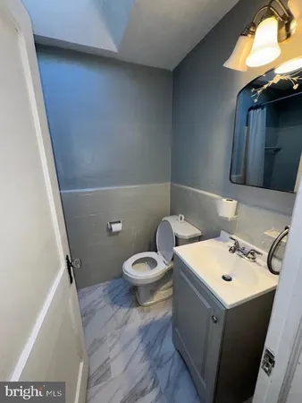a white toilet sitting next to a bathroom sink