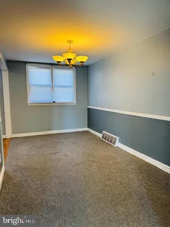 an empty room with a fireplace and painted walls