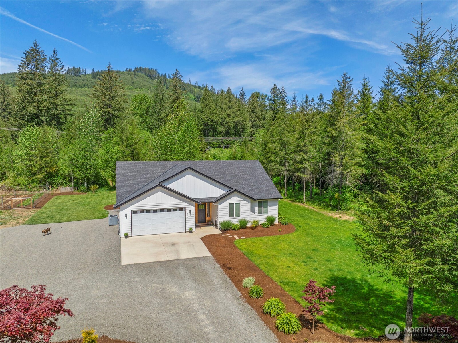266 Fir Road Ariel, WA 98603 - Photo 28 of 32 a house with green field in front of it