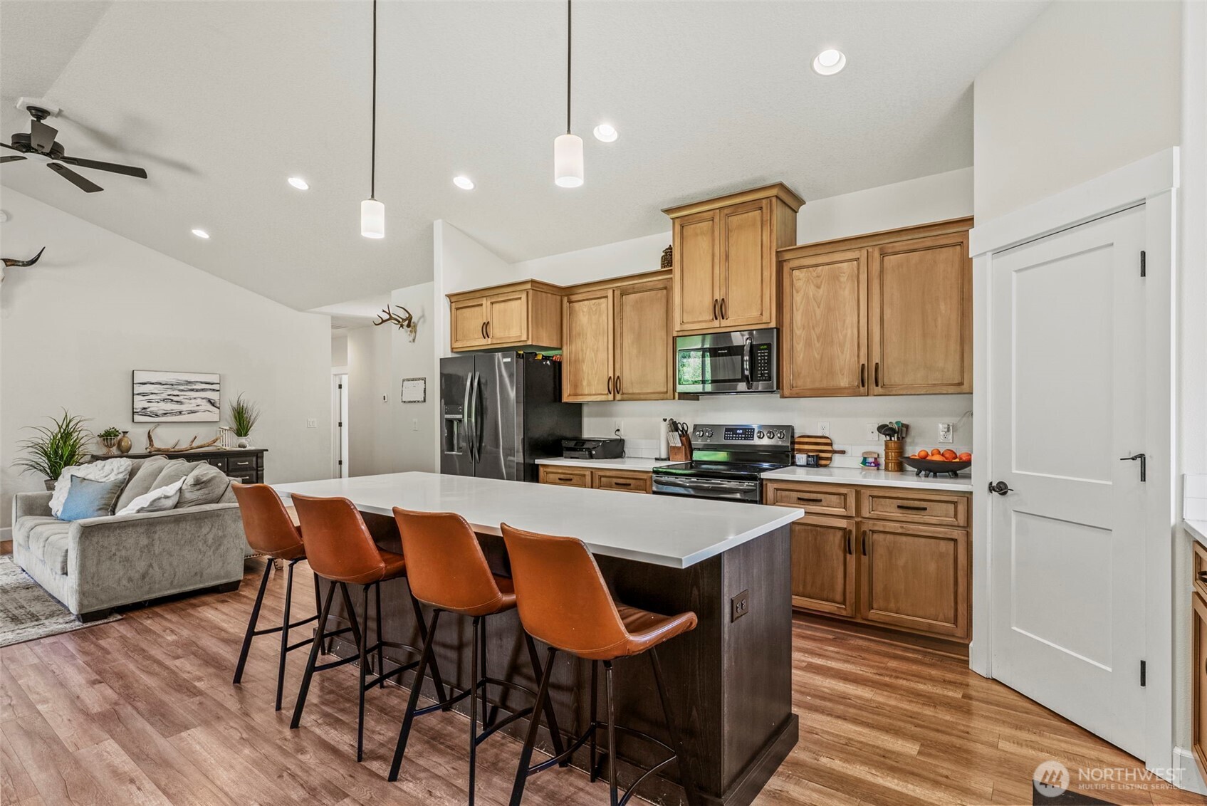 266 Fir Road Ariel, WA 98603 - Photo 4 of 32 a kitchen with granite countertop a dining table chairs refrigerator and microwave