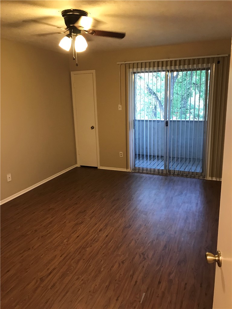 3201 Cougar Trail, Unit A Bryan, TX 77807 - Photo 12 of 15 a view of an empty room with wooden floor and a window