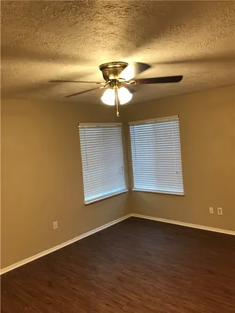 a view of room with hardwood floor and ceiling fan