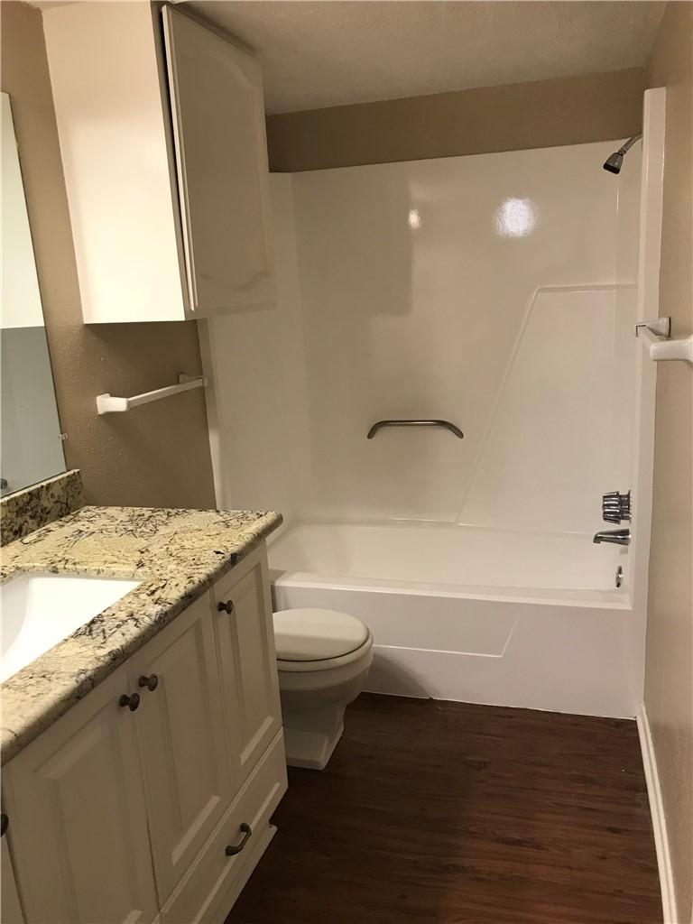 3201 Cougar Trail, Unit A Bryan, TX 77807 - Photo 7 of 15 a bathroom with a granite countertop sink toilet and shower