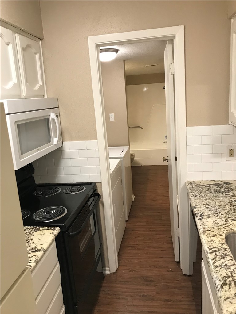 3201 Cougar Trail, Unit A Bryan, TX 77807 - Photo 10 of 15 a kitchen with a sink stove and cabinets