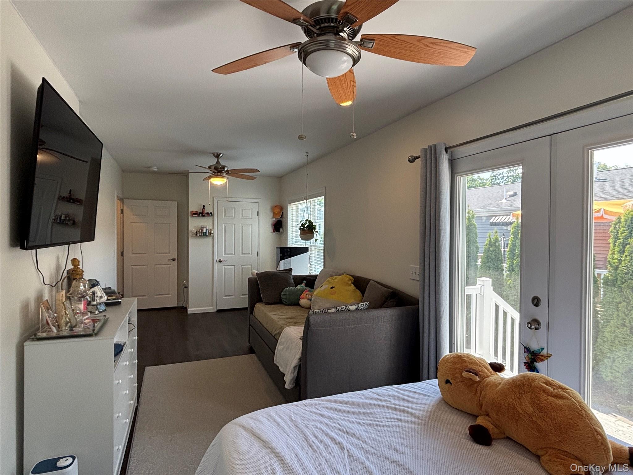 1661 Old Country Road, Unit 563 Riverhead, NY 11901 - Photo 22 of 43 a bedroom with a bed chandelier and a window
