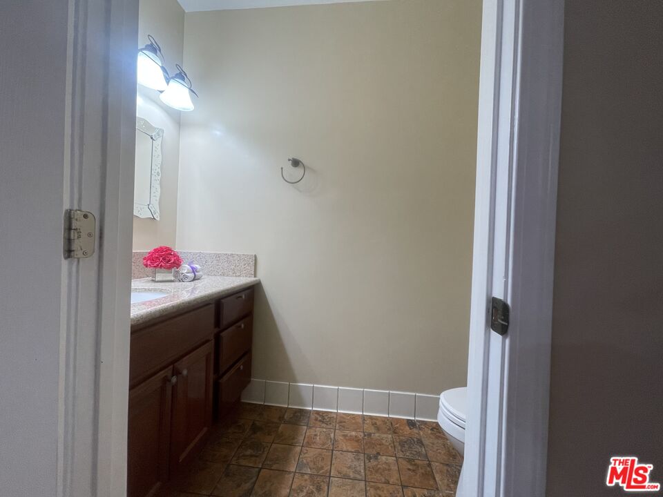904 East Windsor Road, Unit 103 Glendale, CA 91205 - Photo 11 of 26 a bathroom with a sink vanity and a mirror