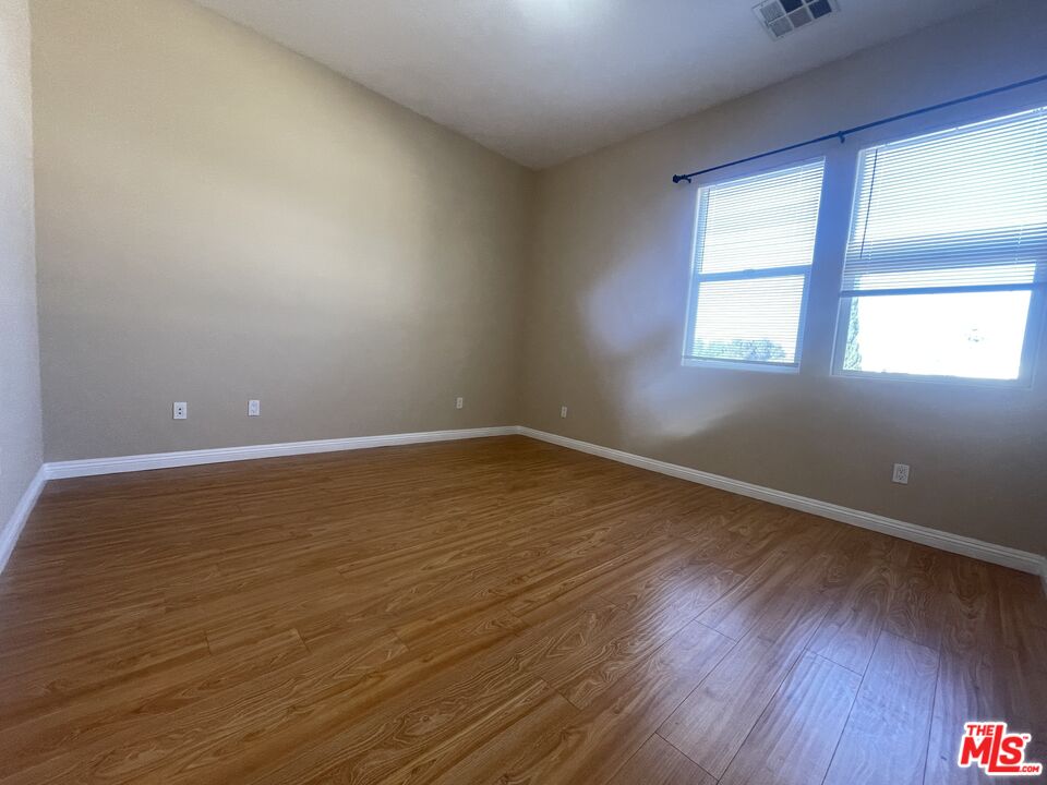 904 East Windsor Road, Unit 103 Glendale, CA 91205 - Photo 15 of 26 an empty room with wooden floor and windows