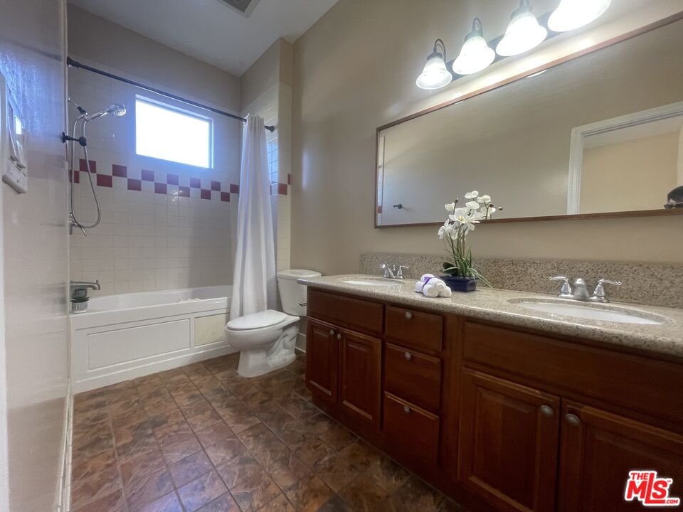 904 East Windsor Road, Unit 103 Glendale, CA 91205 - Photo 18 of 26 a bathroom with a granite countertop sink toilet and shower