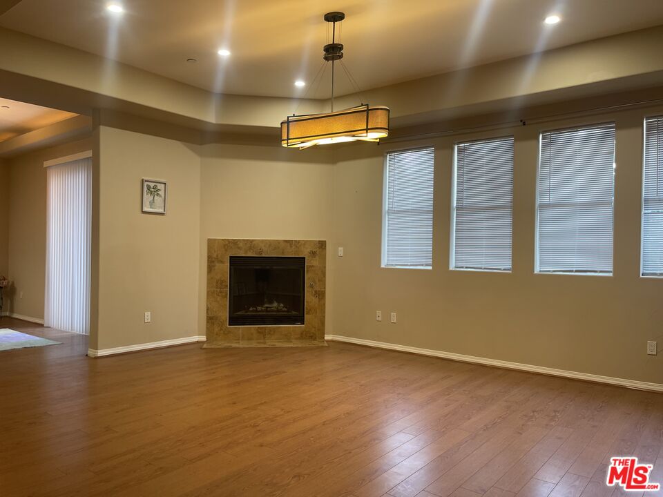904 East Windsor Road, Unit 103 Glendale, CA 91205 - Photo 8 of 26 a view of an empty room with wooden floor and a window