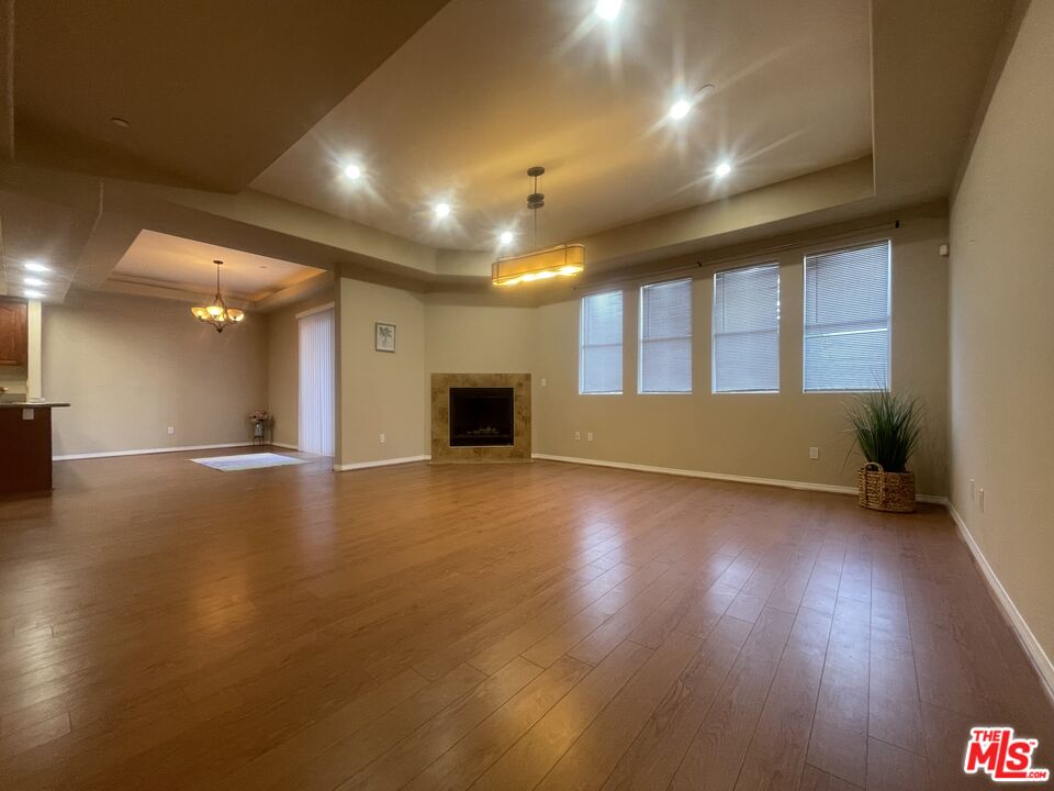 904 East Windsor Road, Unit 103 Glendale, CA 91205 - Photo 9 of 26 an empty room with wooden floor and windows