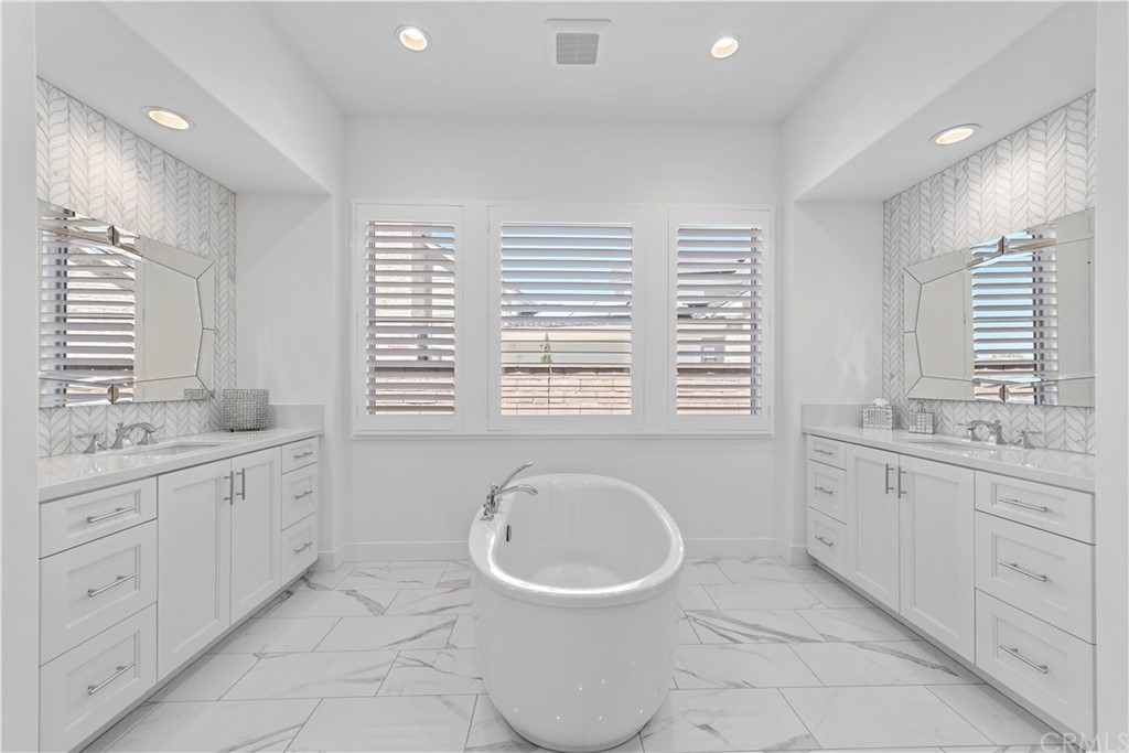 9 Catalina Vista Road Ladera Ranch, CA 92694 - Photo 16 of 41 a bathroom with a granite countertop sink and a bathtub