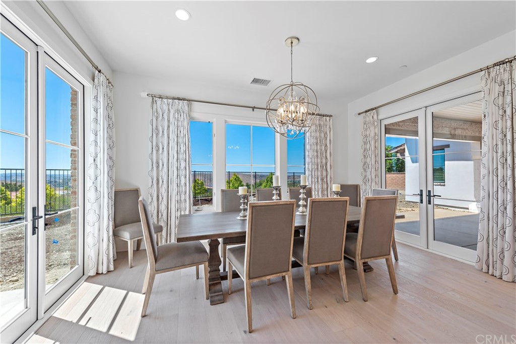 9 Catalina Vista Road Ladera Ranch, CA 92694 - Photo 19 of 41 a view of a dining room with furniture wooden floor and chandelier