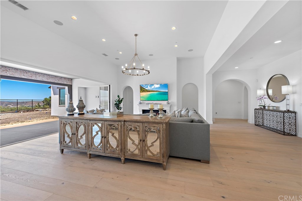 9 Catalina Vista Road Ladera Ranch, CA 92694 - Photo 8 of 41 a living room with furniture a chandelier and a flat screen tv
