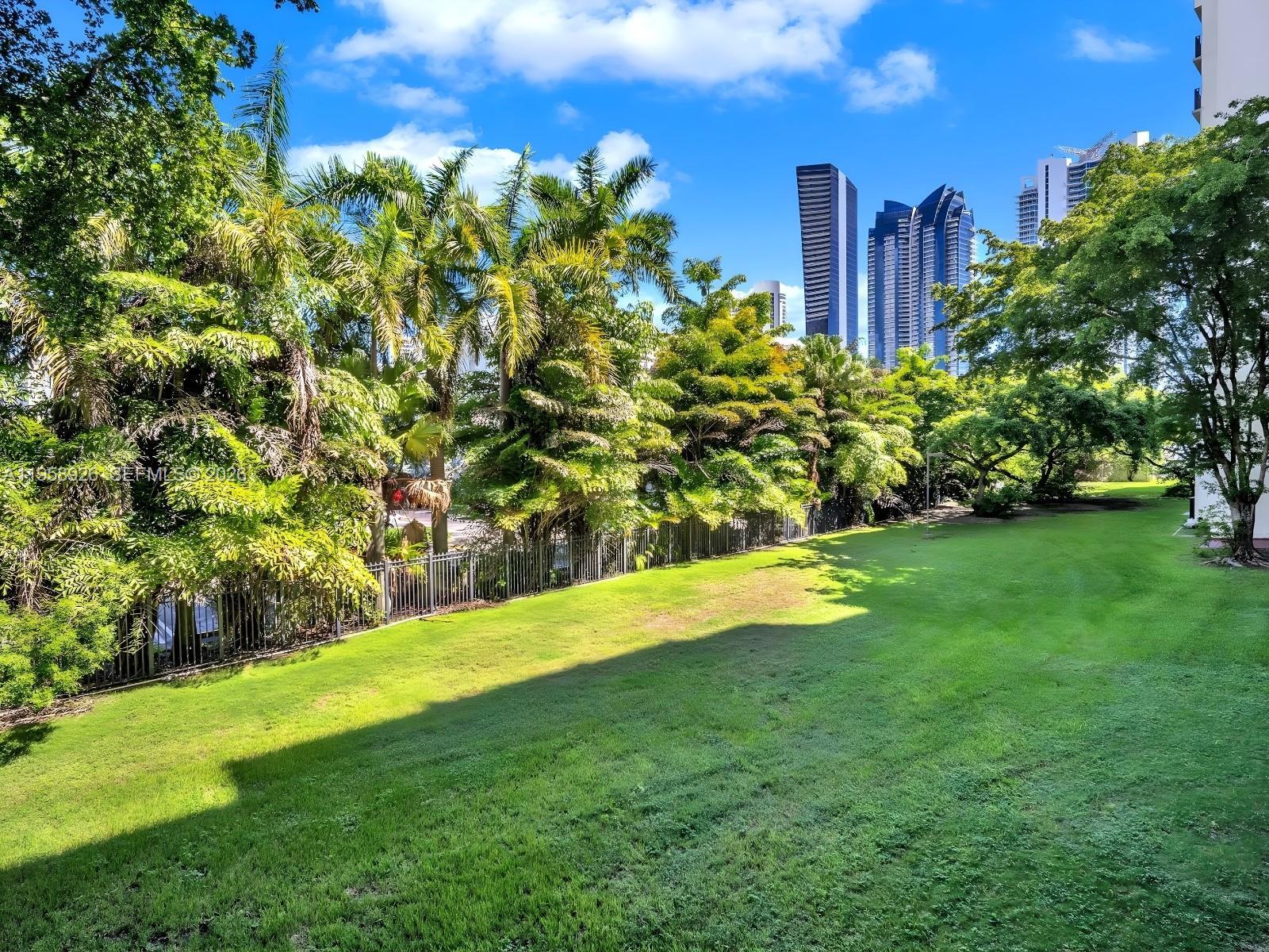17021 North Bay Road, Unit 706 Sunny Isles Beach, FL 33160 - Photo 14 of 14 a view of a garden with a building in the background