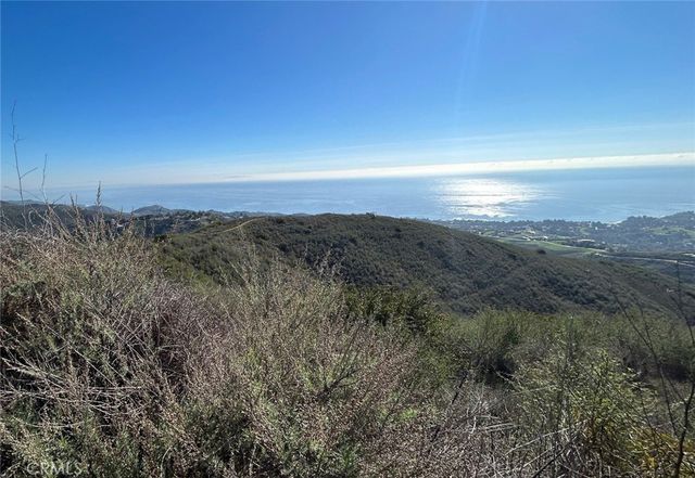a view of sunset and green space