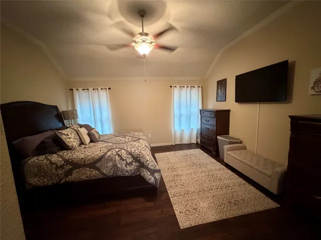 a bedroom with a bed and a flat screen tv