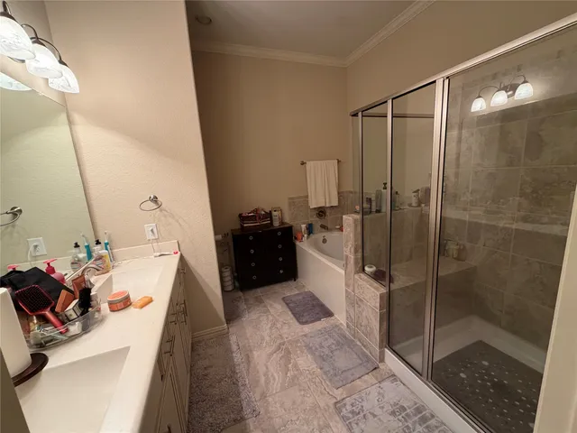 a bathroom with a sink mirror and shower