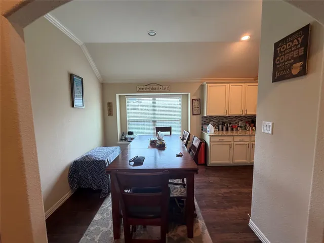 a view of a dining room with furniture and window