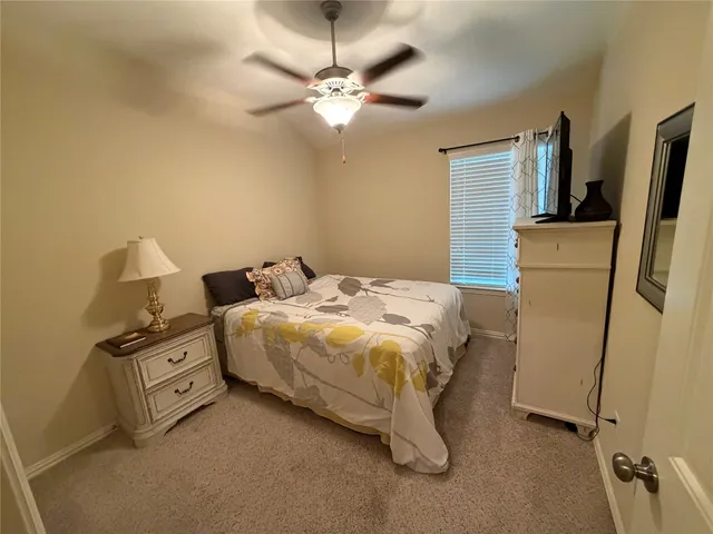 a bedroom with a bed dresser and a window