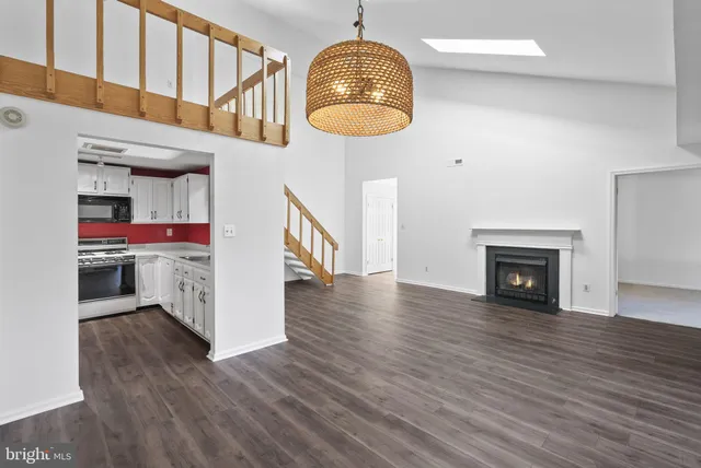 a view of a room with wooden floor and a fireplace