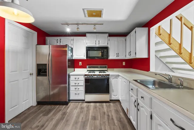 a kitchen with stainless steel appliances granite countertop a stove and a refrigerator