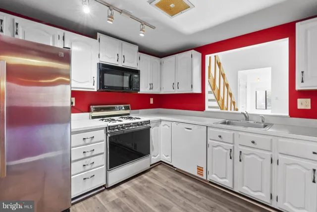 a kitchen with stainless steel appliances granite countertop a stove and a sink