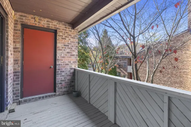 a view of wooden balcony and trees