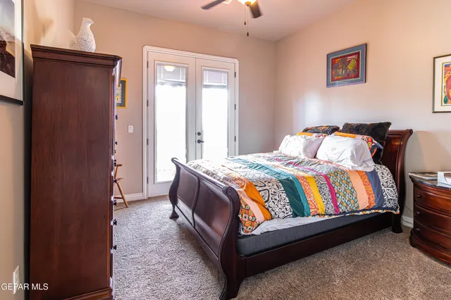 a bed sitting in a bedroom next to a window