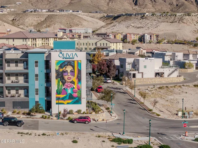 an aerial view of a house with a floor to ceiling window next to a city