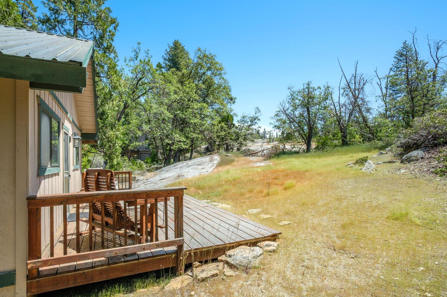 42488 Rock Ledge Road Shaver Lake, CA 93664 - Photo 3 of 26 a view of a swimming pool with wooden floor and fence