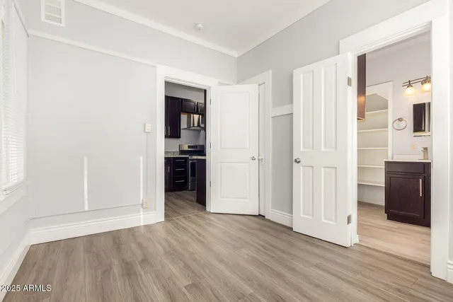 a view of empty room with wooden floor and cabinet