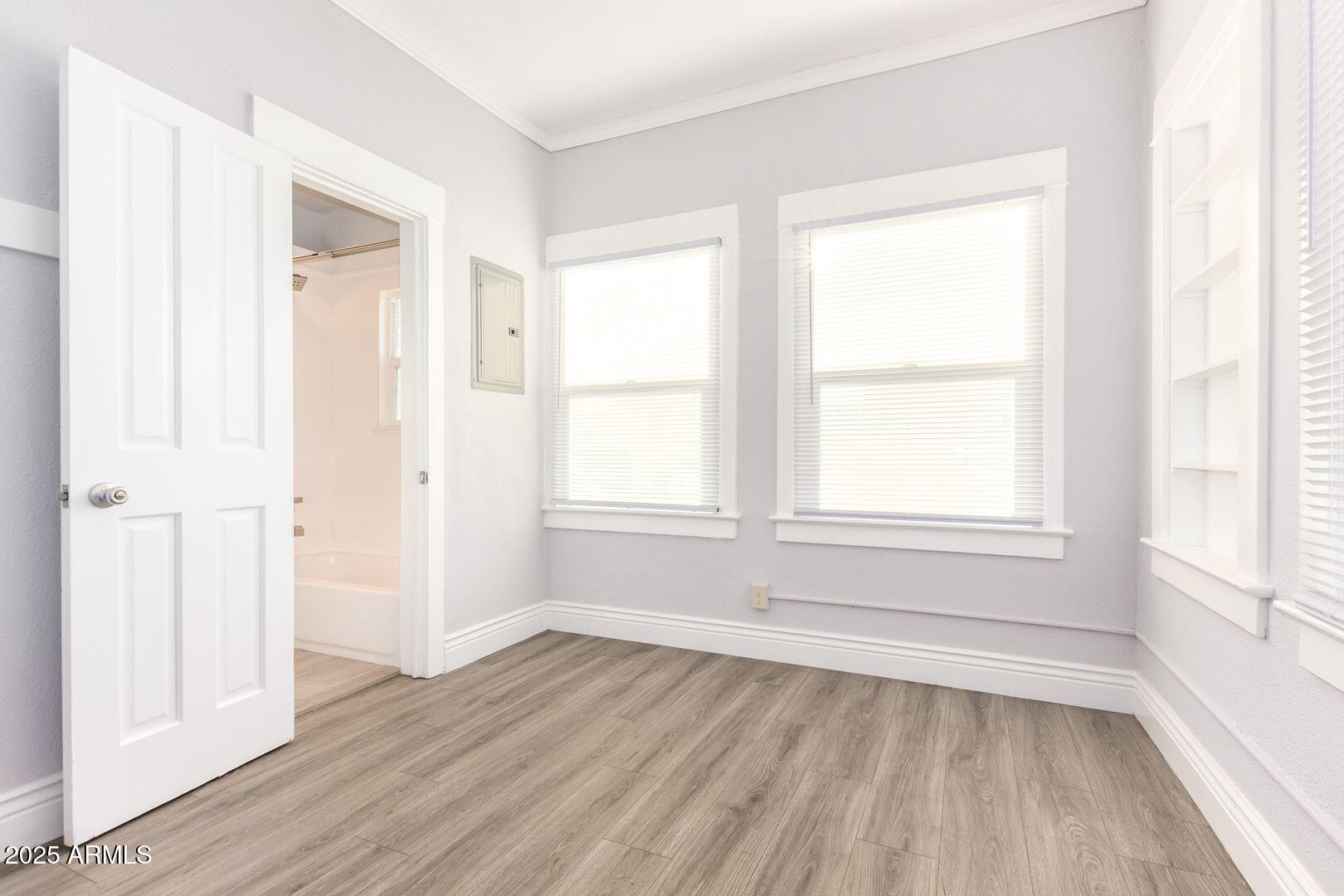 822 North 7th Street, Unit 2 Phoenix, AZ 85004 - Photo 12 of 18 an empty room with wooden floor and windows