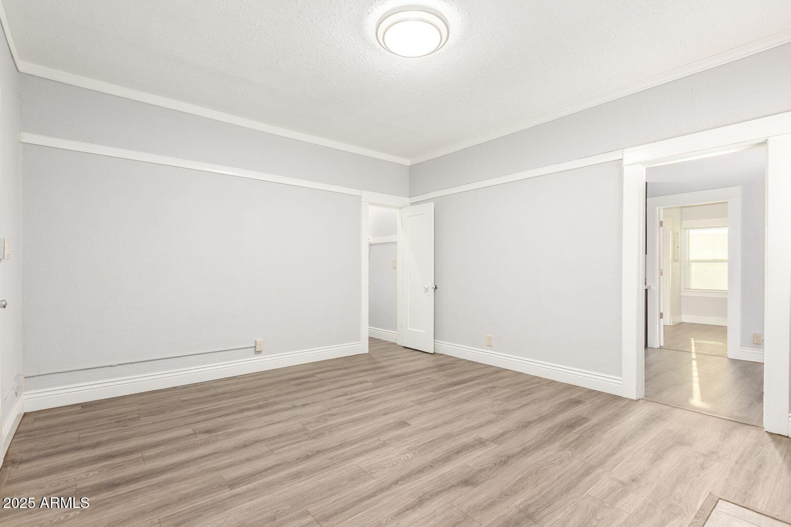 822 North 7th Street, Unit 2 Phoenix, AZ 85004 - Photo 14 of 18 an empty room with wooden floor and windows