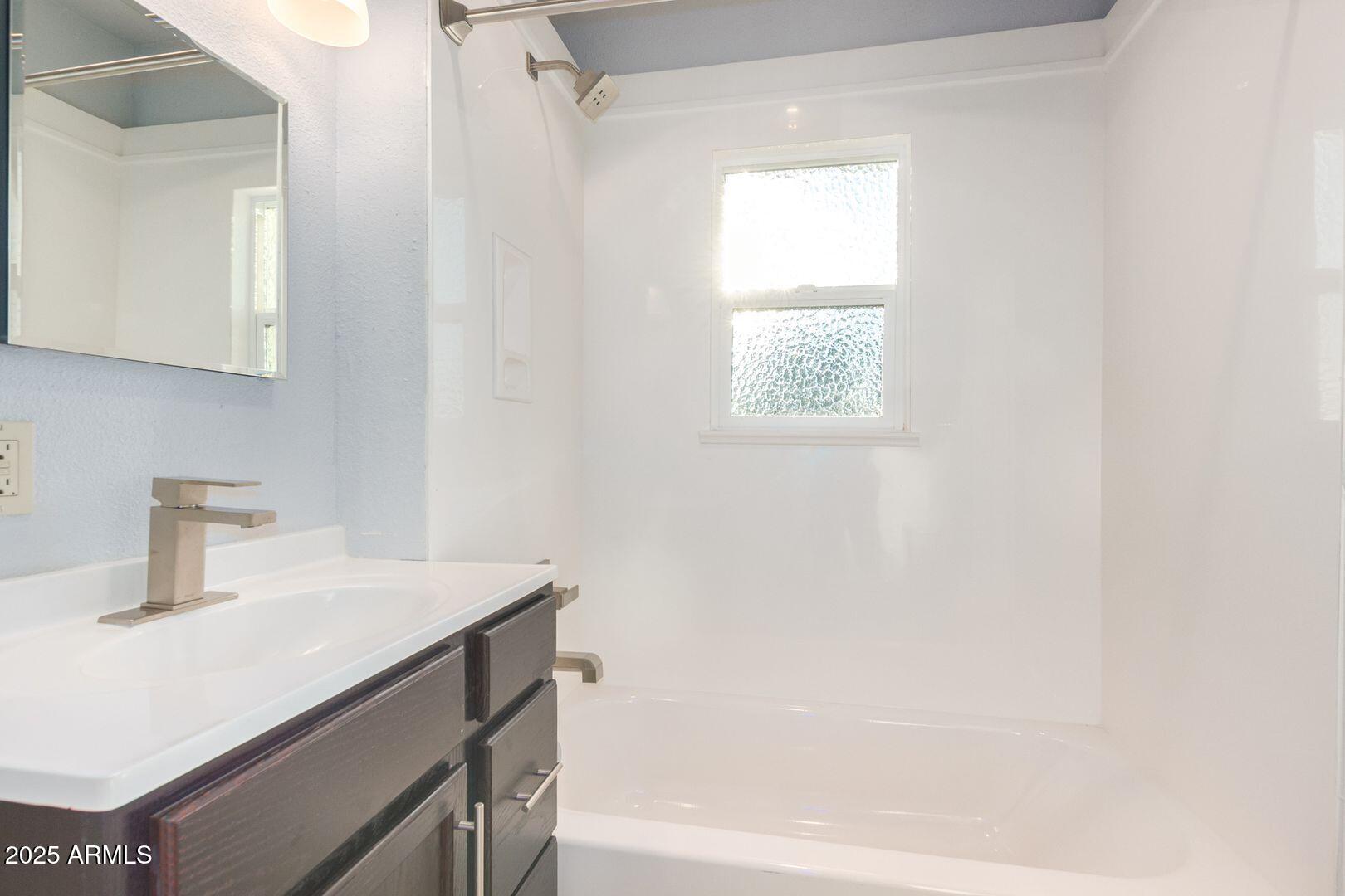 822 North 7th Street, Unit 2 Phoenix, AZ 85004 - Photo 16 of 18 a bathroom with a sink a vanity and a bathtub