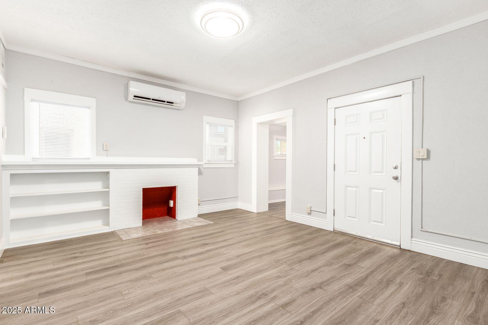 822 North 7th Street, Unit 2 Phoenix, AZ 85004 - Photo 2 of 18 an empty room with wooden floor and windows