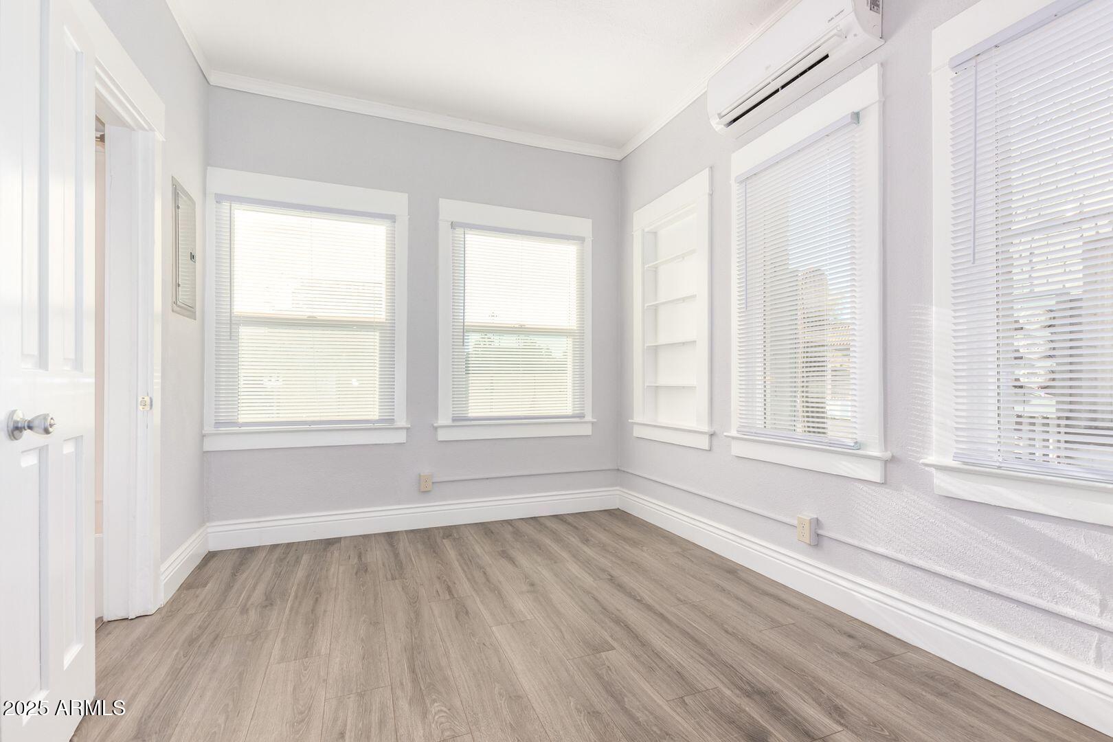 822 North 7th Street, Unit 2 Phoenix, AZ 85004 - Photo 6 of 18 an empty room with wooden floor and windows