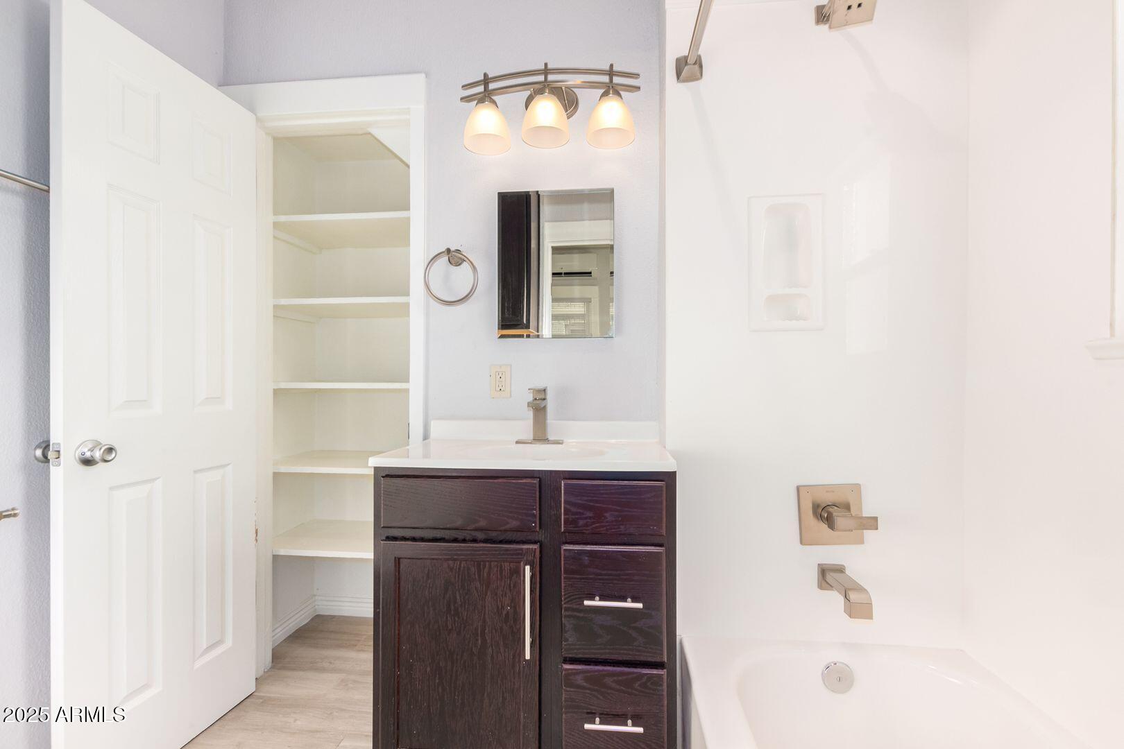 822 North 7th Street, Unit 2 Phoenix, AZ 85004 - Photo 9 of 18 a bathroom with a sink and a mirror