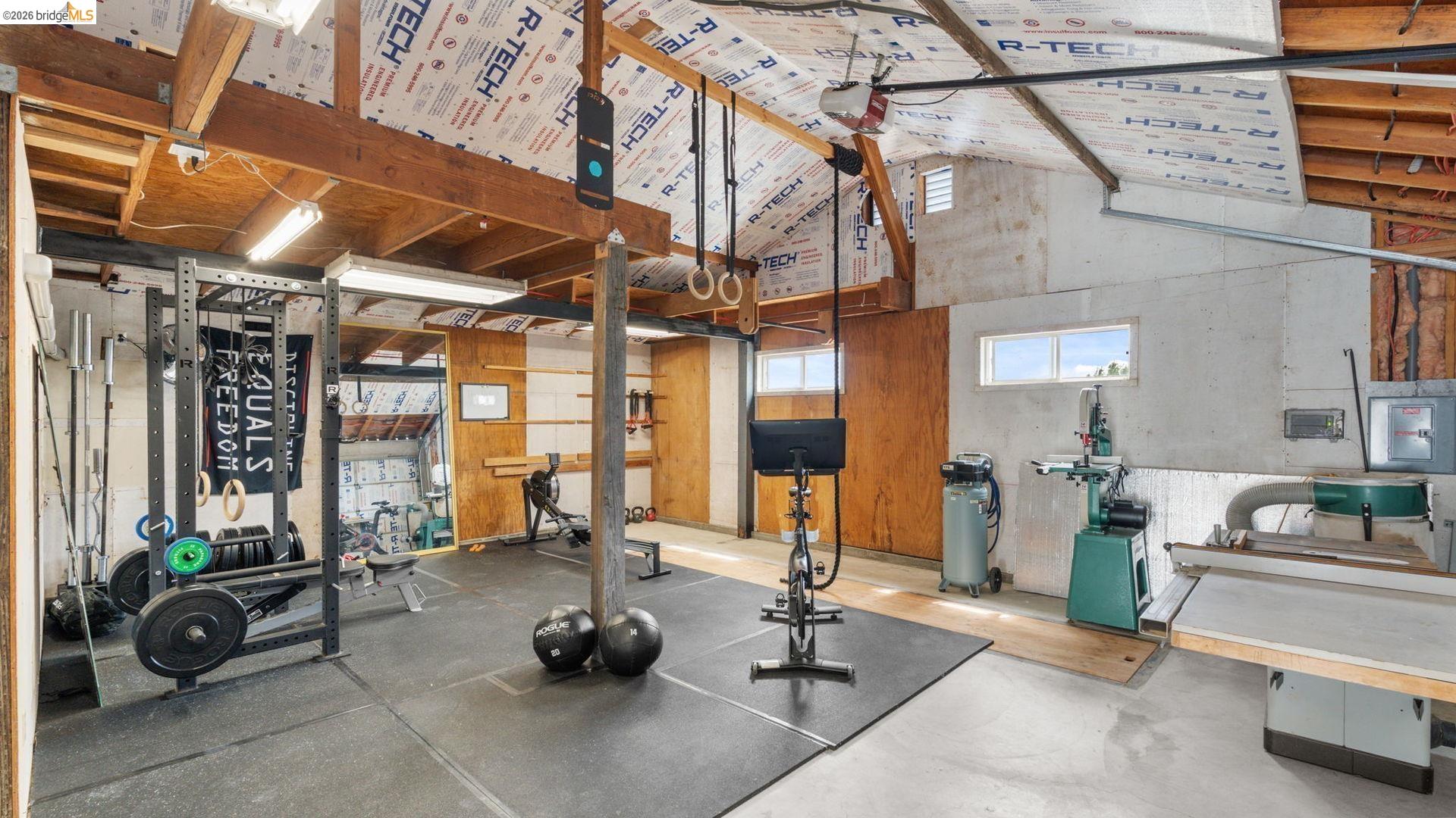 700 Brownstone Road Oakley, CA 94561 - Photo 44 of 58 Spacious interior with exposed wooden beam ceiling, concrete walls, and large windows